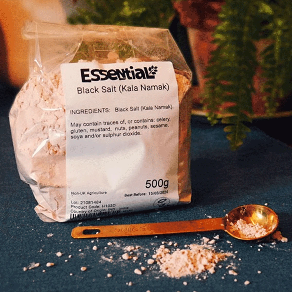 Packaged Black Salt on a table with a measuring spoon