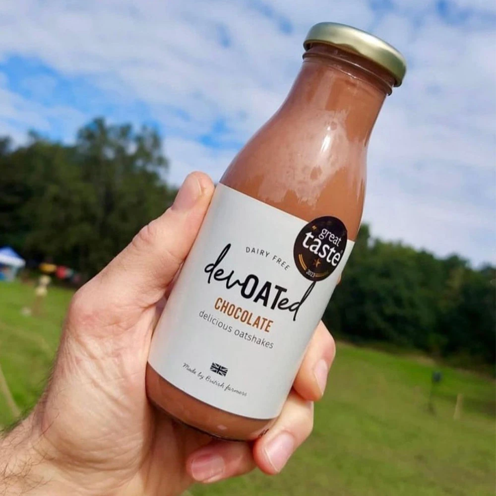 A bottle of devOATed oatshake held in a hand