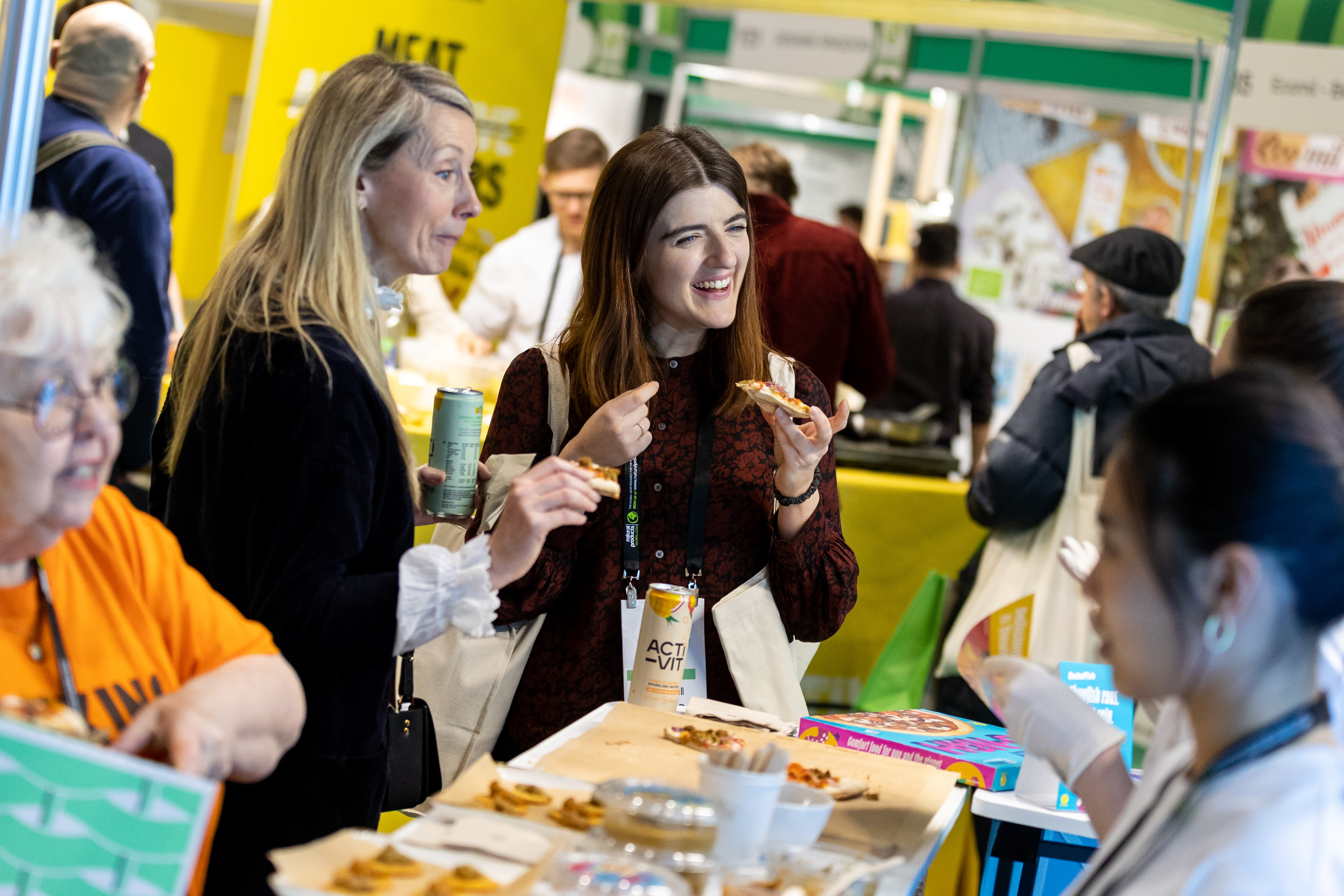 Food exhibitors with attendees at the Natural & Organic Products Expo